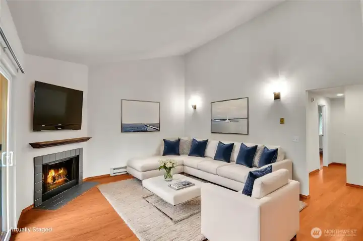 Top-floor end unit featuring a cozy fireplace and vaulted ceilings, creating an open and airy living space. The entire interior has been freshly painted; move in ready! Virtually staged.