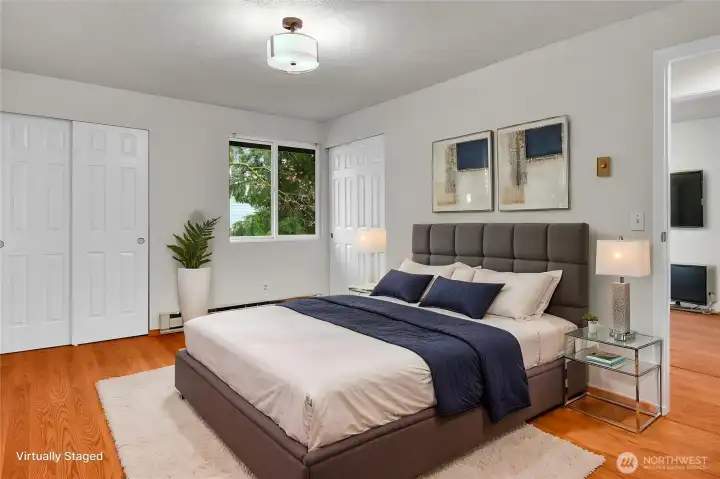 Primary bedroom featuring dual closets and an attached ¾ bath for added convenience. Virtually staged.
