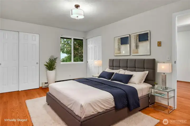 Primary bedroom featuring dual closets and an attached ¾ bath for added convenience. Virtually staged. Primary bedroom featuring dual closets and an attached ¾ bath for added convenience. Virtually staged.