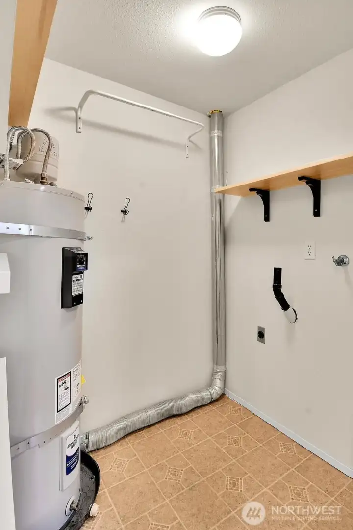 Utility room with built-in shelving—ideal for extra storage or pantry use.