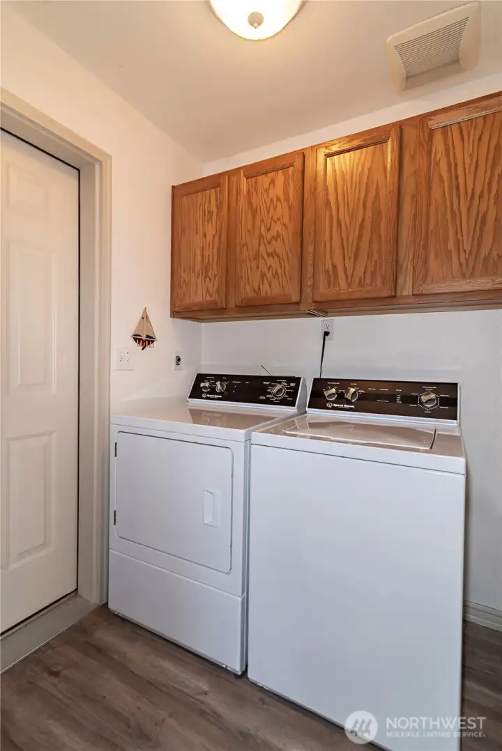 Laundry room provides even more storage solutions and has a zero step transition into the garage.
