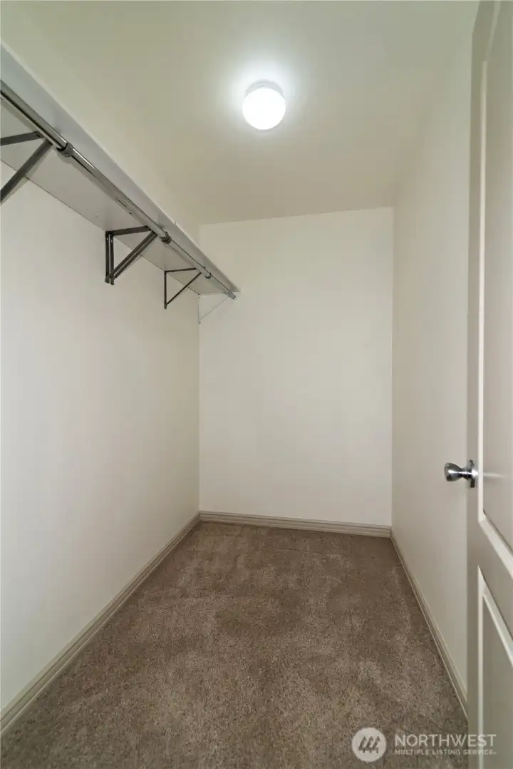Primary bedroom walk in closet