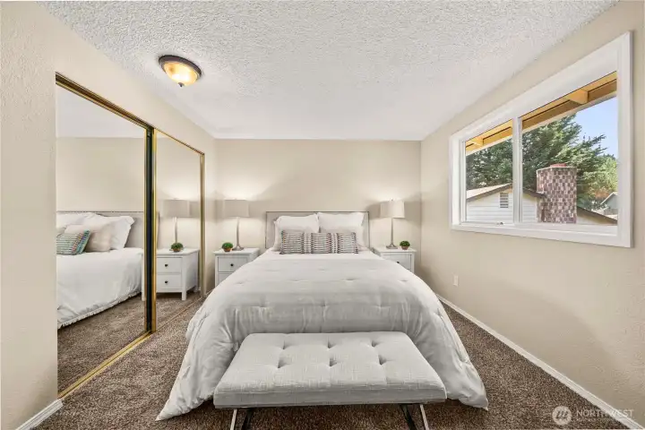 Quiet primary suite overlooks the backyard.