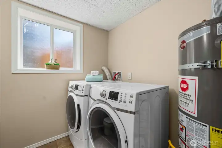 lower level laundry room and 1/2 bath.  Washer and dryer stay.