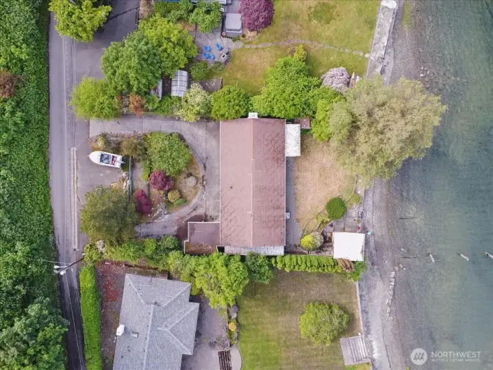 Drone shot of lot, house and waterfront.