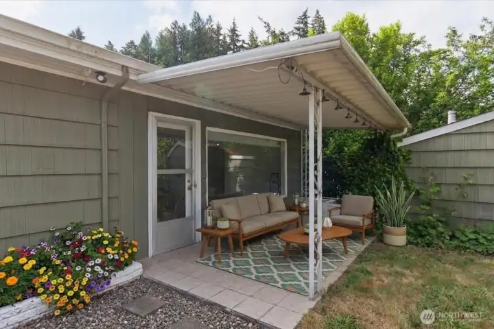 Covered back patio, digitally staged.