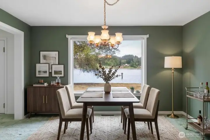 Dining room with incredible views of Dyes Inlet and Phinney Bay. Digitally Staged.
