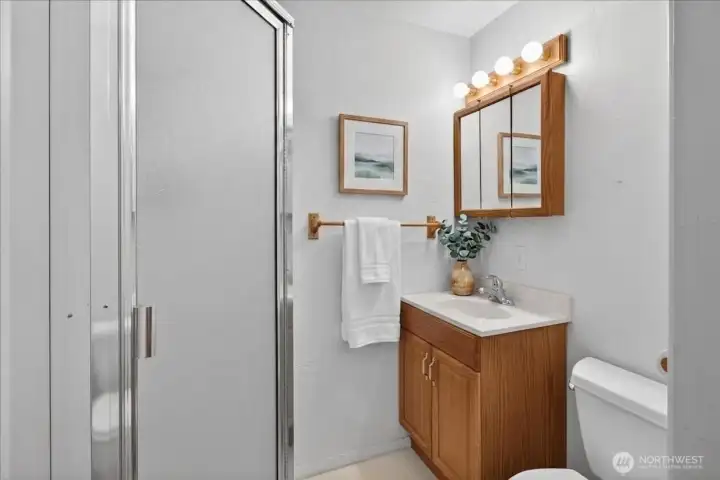 3/4 bath in primary suite. Digitally Staged.