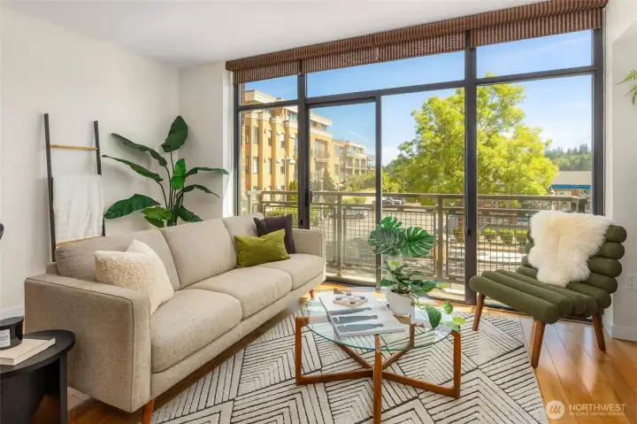 A dramatic wall of floor-to-ceiling windows fills the home with cheerful, natural light. A dramatic wall of floor-to-ceiling windows fills the home with cheerful, natural light.