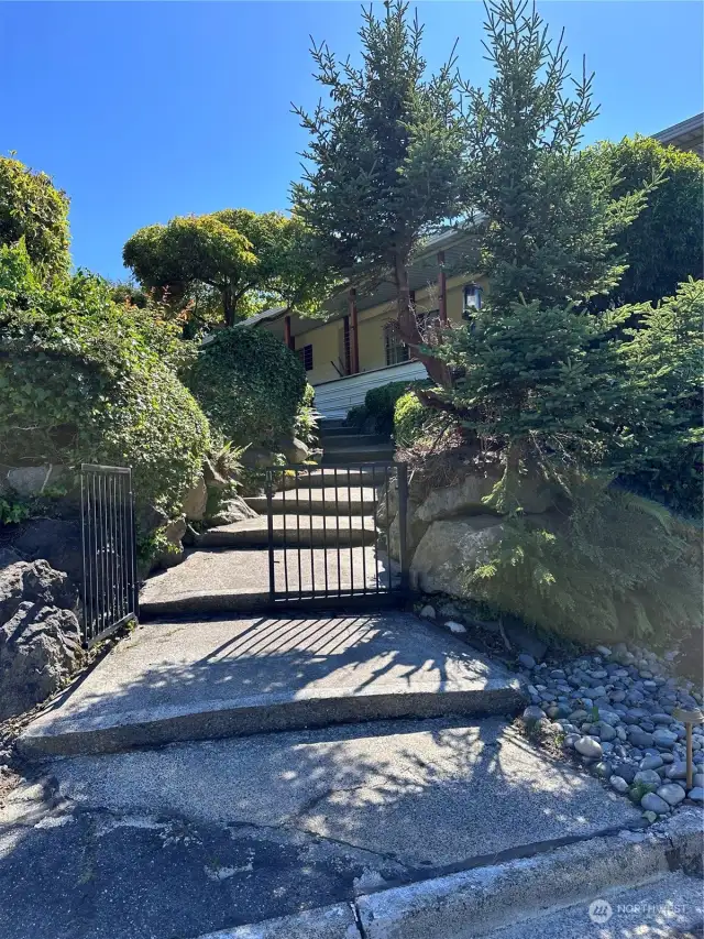 Beautiful gated walk to home. Walking up is not needed as driveway leads to covered parking and entry.