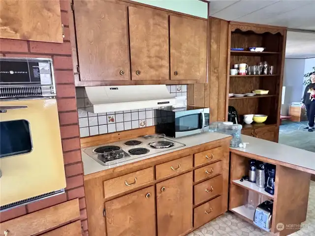 Walls of cabinets in this kitchen with serving bar, and additional built  in cabinet.