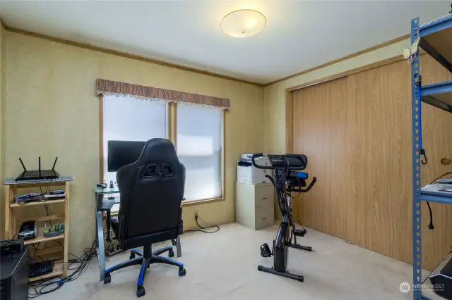 Bedroom #1, currently utilized as an office and exercise space