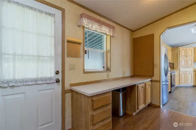 Hallway off of kitchen leading to rear entry & laundry. Convenient built-in work station