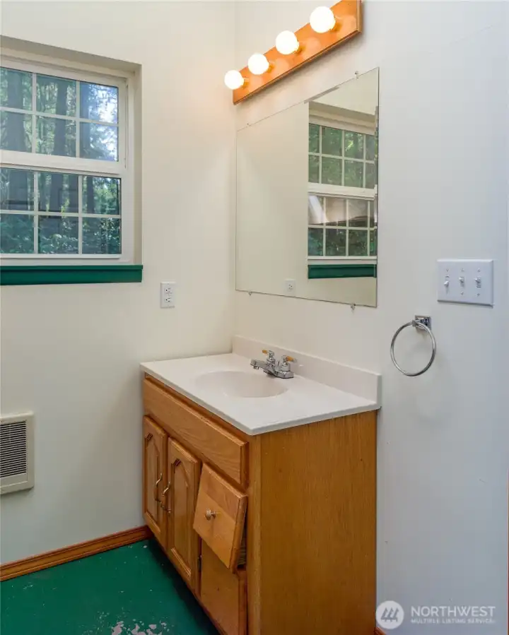 Sink vanity in bathroom through right door.