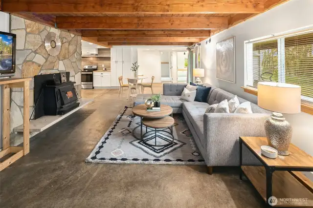 Downstairs is a rustic rec room with wood burning insert. Look at those beam ceilings!