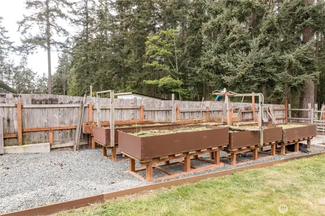 Backyard has raised garden beds and...