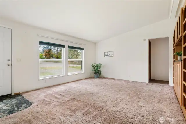 Spacious vaulted Living room with built in bookcases and cabinets