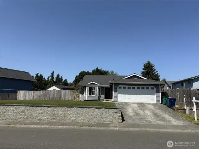 Large front lawn with sprinklers