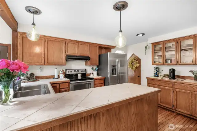 Kitchen – Wraparound tile countertops and abundant cabinet space for easy prep and storage.