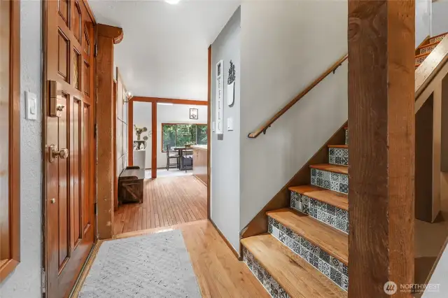 Front Entry – Warm, rustic charm with hardwood floors, rich wood accents, and natural wood trim.