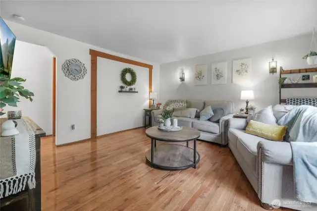 Living Room – Bright, inviting gathering space with farmhouse details and hardwood floors.