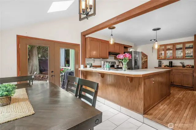 Kitchen – View from dining area shows open layout and breakfast bar perfect for casual meals.
