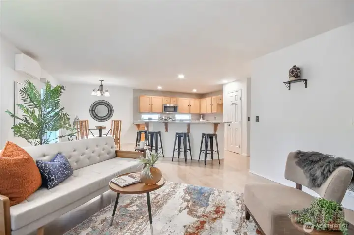 The open kitchen features a convenient eating bar, perfect for casual dining or extra seating while entertaining.