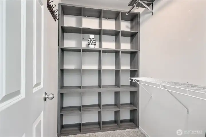 Primary Suite includes a walk-in closet with built-in storage perfect for organizing shoes, bags, and accessdories.