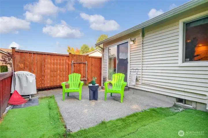 Private backyard has some no maintenance turf.