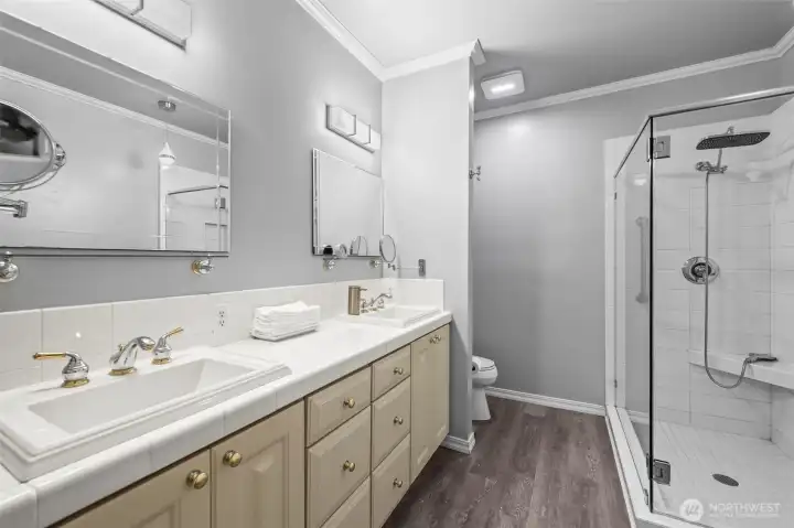 Double vanity and glass rain shower in primary bath