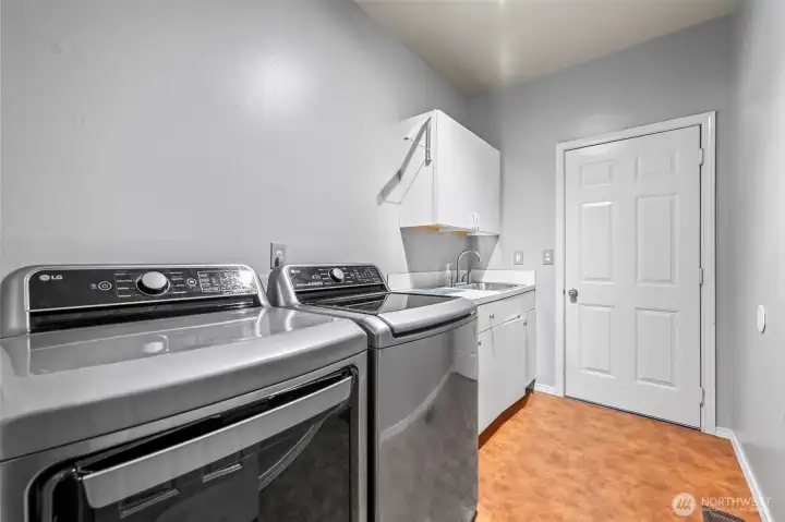 Laundry with tub sink and cabinets