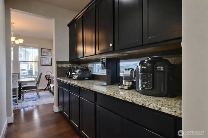 Butler's Pantry between dining room and kitchen. Ample counter space, cabinets and outlets for all countertop appliances. An organizational dream! Walk in Pantry located to the left.