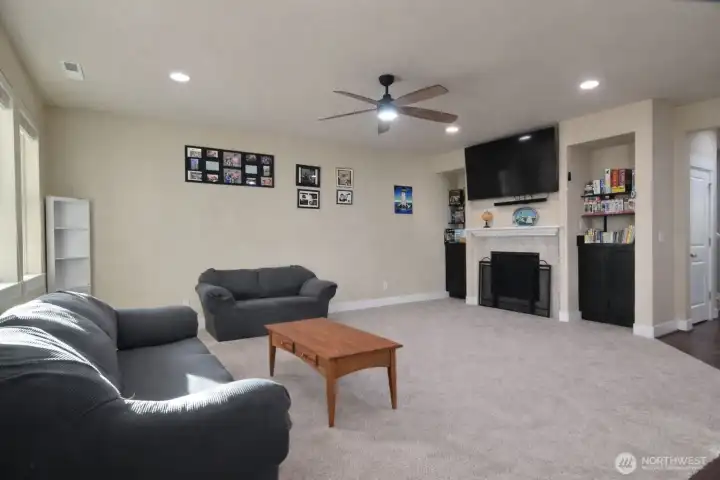 Living room with built in storage on each side of the fireplace.