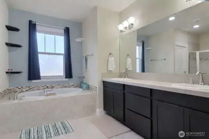 Primary bathroom, dual vanity, soaking tub and shower.