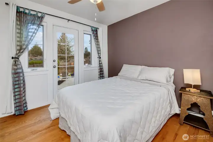 Main floor bedroom with surprisingly big walk in closet and a door to the back deck and yard