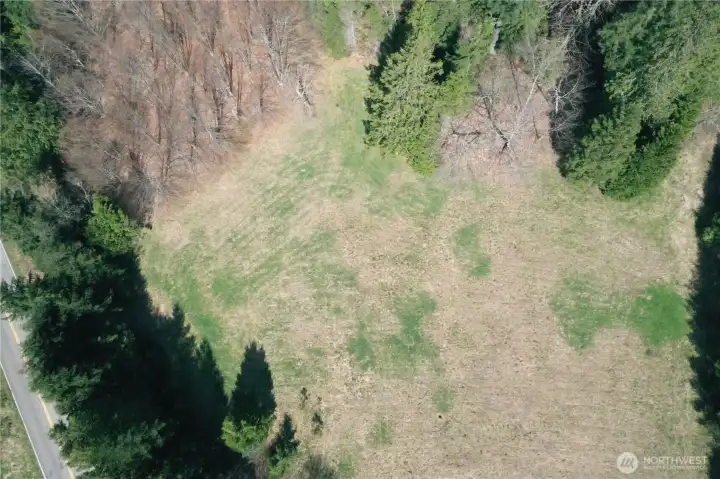 Zoom out of field/meadow area out to the right of the gate