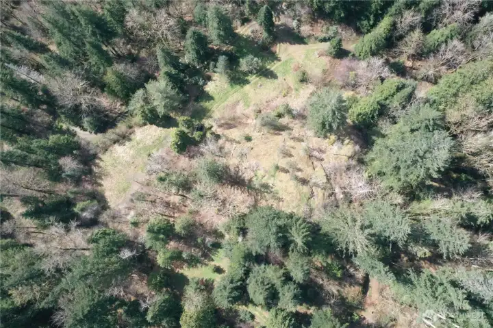 Aeriel drone shot of secondary cliffs with potential building spot(s).  Existing one room cabin trail and site is upper right portion of photo.