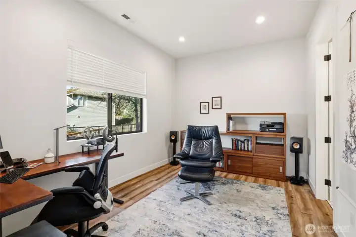 Main level bedroom that would be the perfect office or flex space with en suite bathroom.