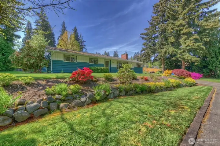 1.2 acre lot with a lovingly cared for home plus detached garage/extra finished space, and storage room.  Seperate potting room and storage in the well house.