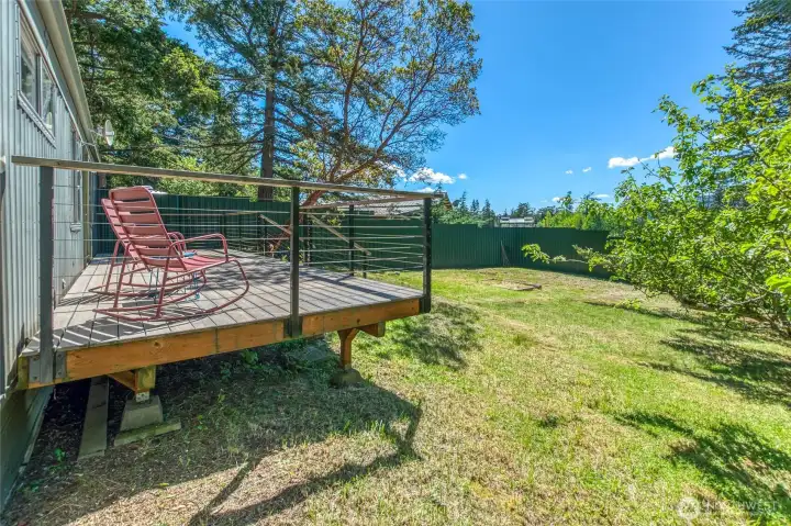 Deck and fenced yard in front of the manufactured home. Deck and fenced yard in front of the manufactured home.