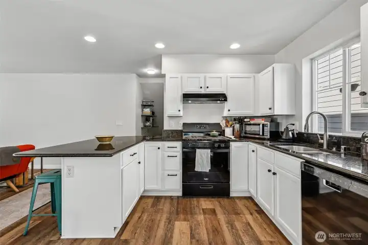 U-shaped kitchen with granite countertops