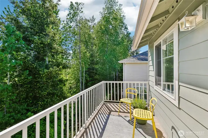 Deck off primary bedroom overlooks the greenbelt and trail