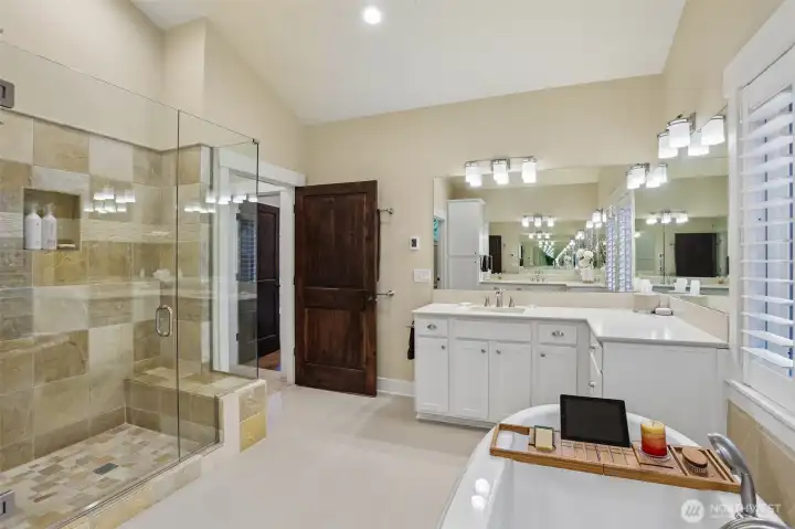 two vanities, glass shower and soaking top