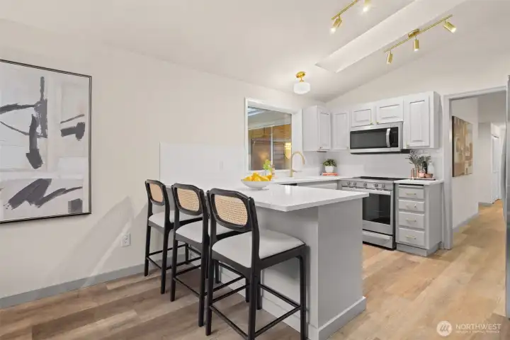 Additional informal eating space at the kitchen bar top.