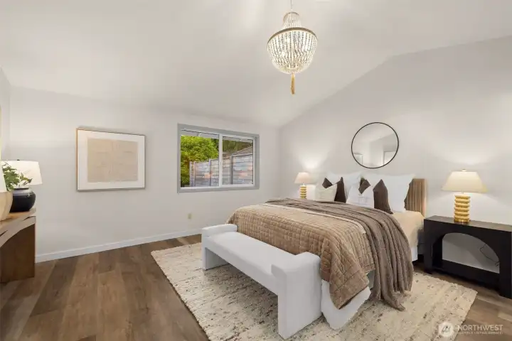 Spacious primary with vaulted ceilings.