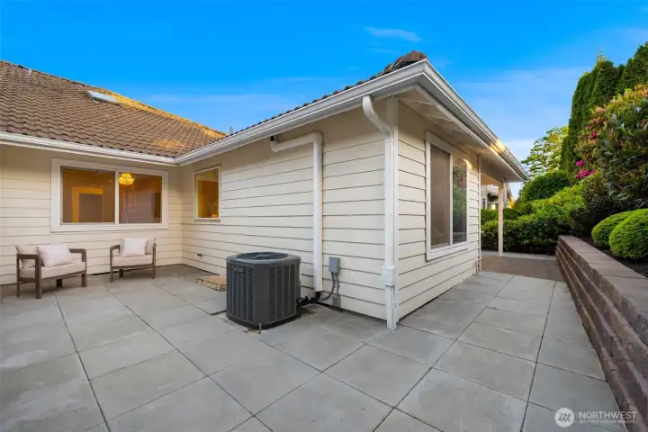 Wrap-around private patio space with newer pavers. Heat pump installed in 2023.