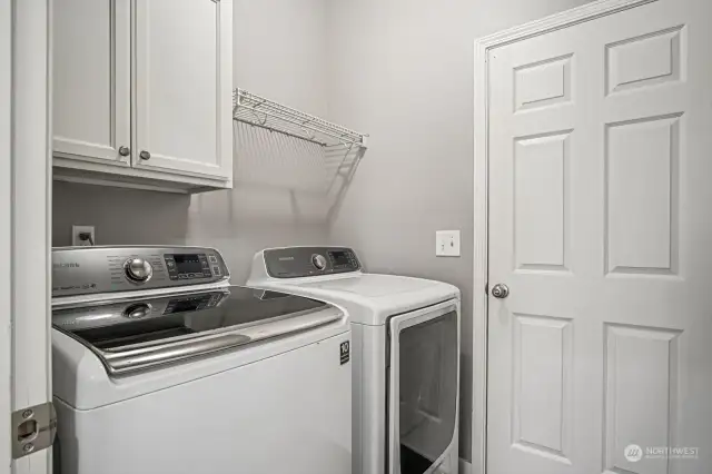 Laundry room off kitchen with door to garage