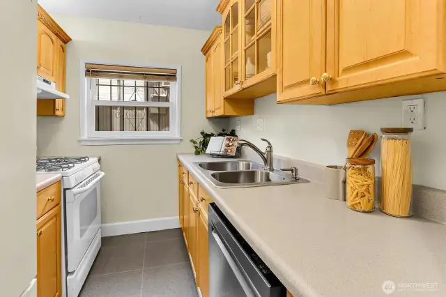 Kitchen has lots of counter space and a four burner gas cooktop.