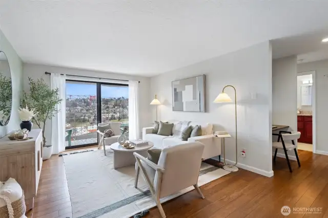 Large Living Room with engineered hardwood throughout and sliding door to a view deck.