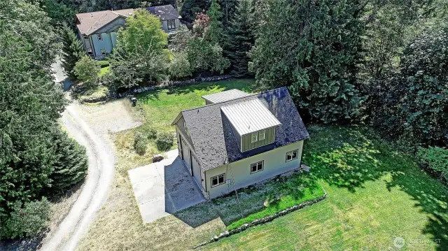 Winding drive leads past RV garage with RV or 4 car parking, separate apartment above, electric charging station to  4000sf , 4 bedroom , 3 1/2 bath home with sunset views. Attached 2 car garage and workshop.